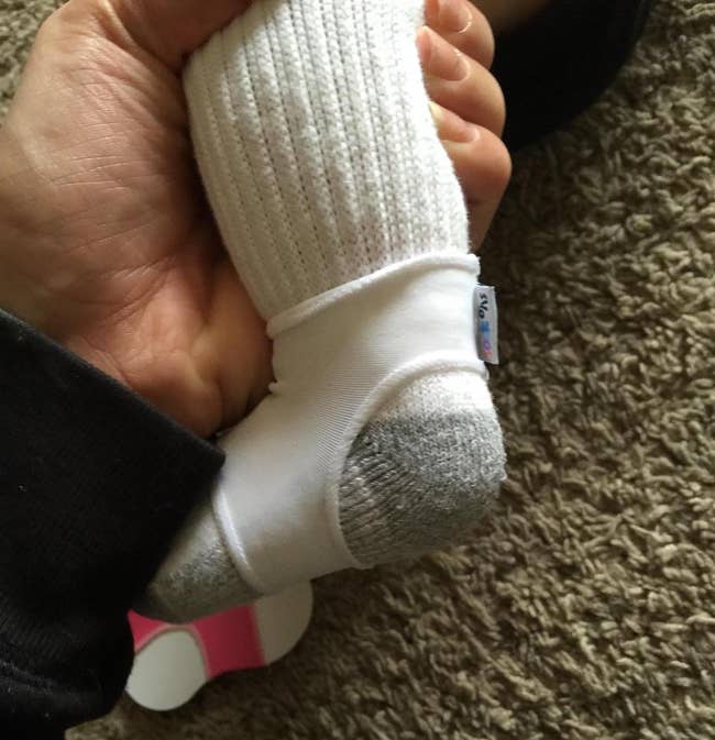 the white sleeve wrapped under a baby's foot and around the ankle