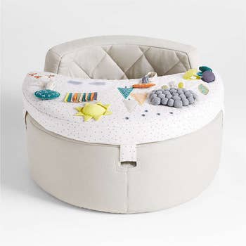 Interactive babe spot with artifact attachments, including textured and colorful elements, designed for engagement and development
