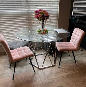 Reviewer image of the coffee table and pink chairs