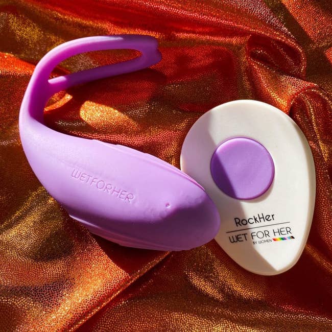 Purple wearable vibrator next to white wireless remote