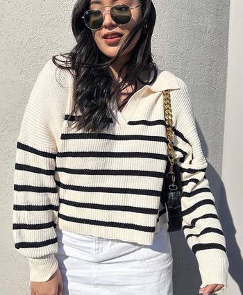 A reviewer wearing the striped sweater
