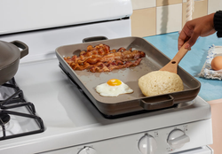 gray oven pan being used as a griddle to make breakfast