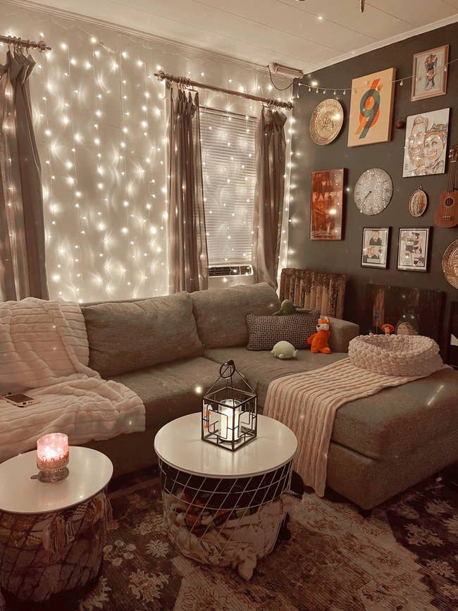 A photo of the writer's living room with the string lights hung up behind her couch