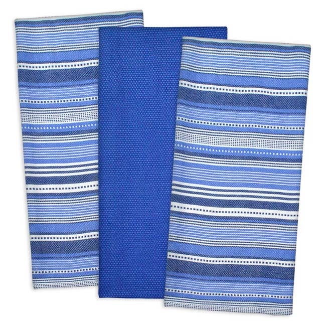 Three blue tea towels with patterns