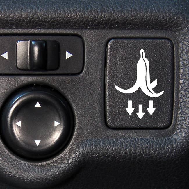 a banana peel decal on a button inside of a car
