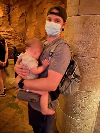 reviewer using hip carrier to carry baby