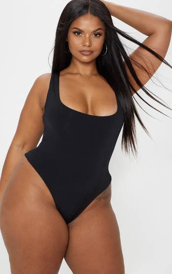 model posing in the black bodysuit