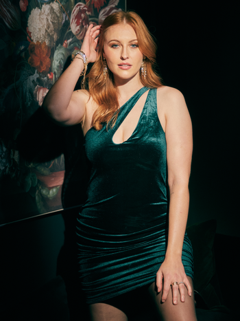 A model wearing the dress in emerald green