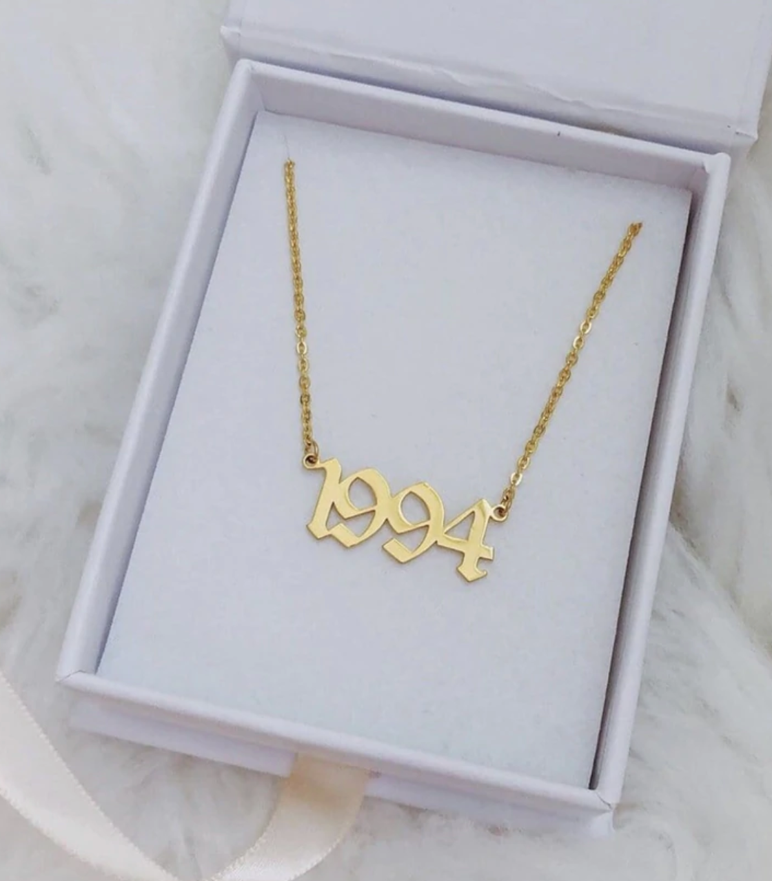 a gold 1994 necklace 