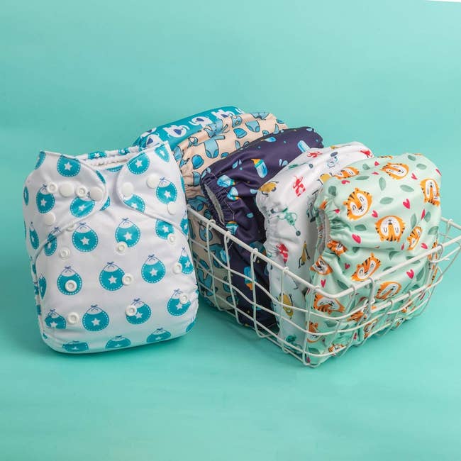 six cloth diapers in various colorful patterns