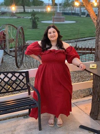 reviewer wearing the dress in red