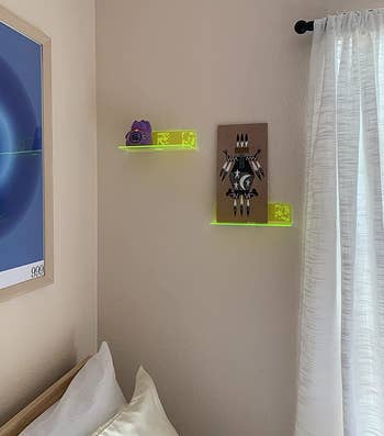 reviewer photo of the neon yellow shelves hung up in a bedroom