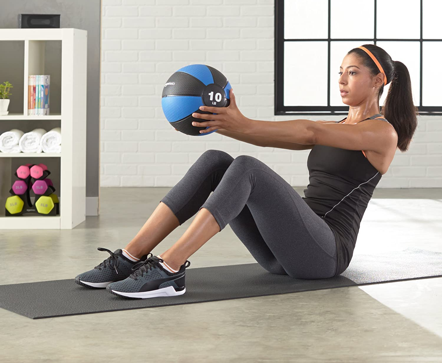 model uses blue 10-pound exercise ball to do core moves at home