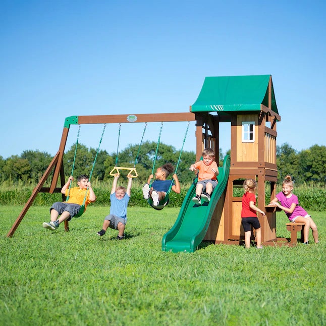 six kids playing on a wooden and green plastic swing set