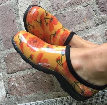 Reviewer's yellow clogs with orange flowers