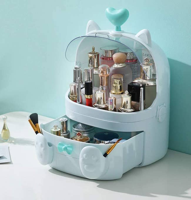 makeup organizer with cat ears, and feet on the drawer 