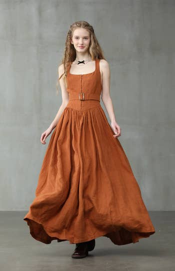 model wearing orange linen corset dress