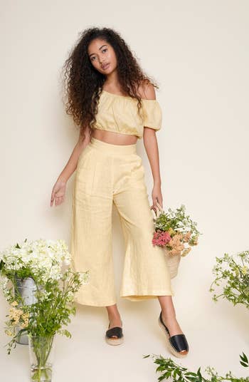 model in yellow linen pants with a matching top