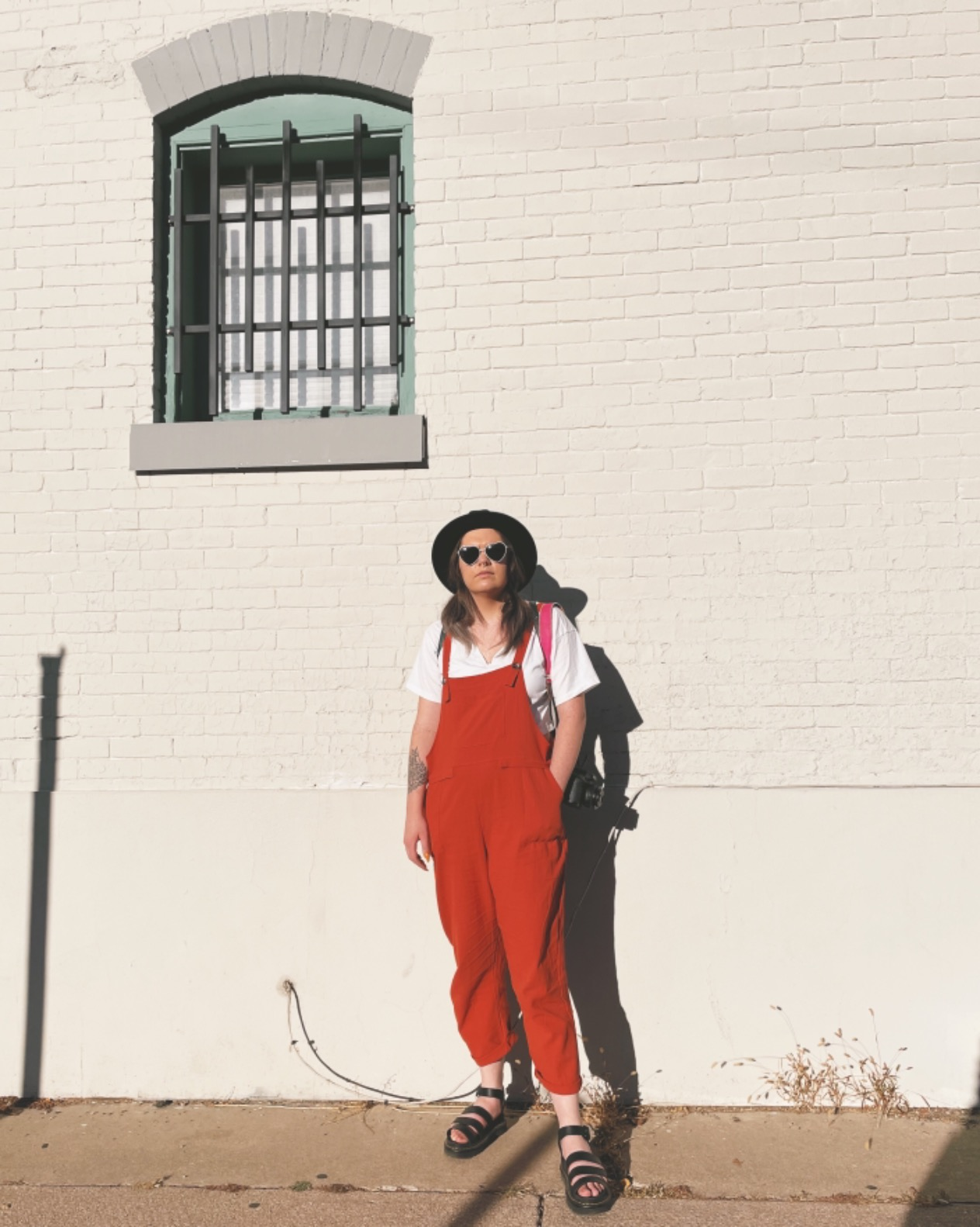 reviewer wearing the brick red overalls outside
