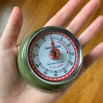 Hand holding a Zassenhaus kitchen timer 