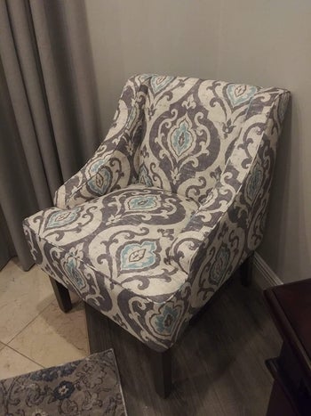 reviewer photo of their gray, white, and blue patterned accent chair