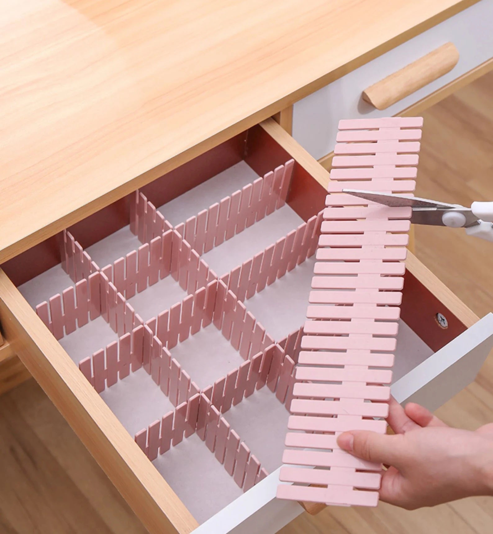 person cutting a thin drawer divider