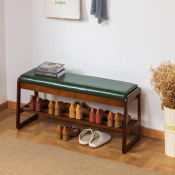wooden seat  with cushion apical  and a support  beneath   the spot   to store   shoes