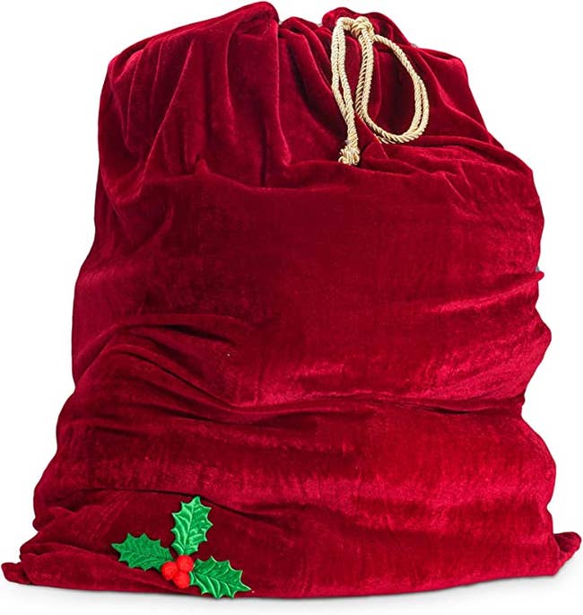 giant red santa bag with mistletoe in corner