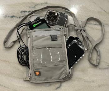 reviewer's pouch with tons of worldly inside