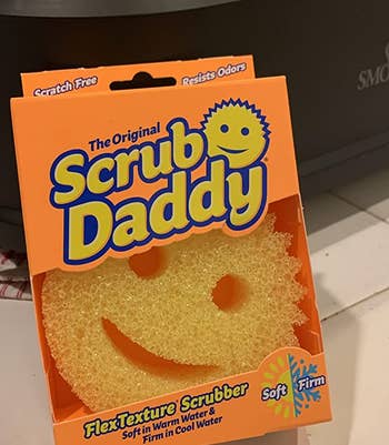 the yellow scrub daddy in its orange box
