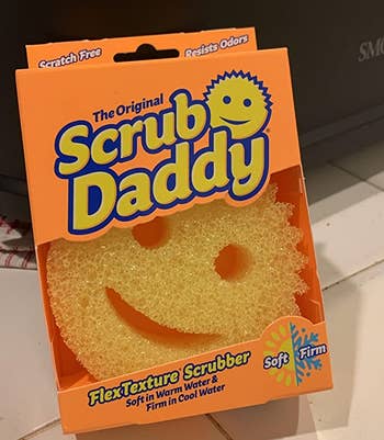 the yellow scrub daddy in its orange box