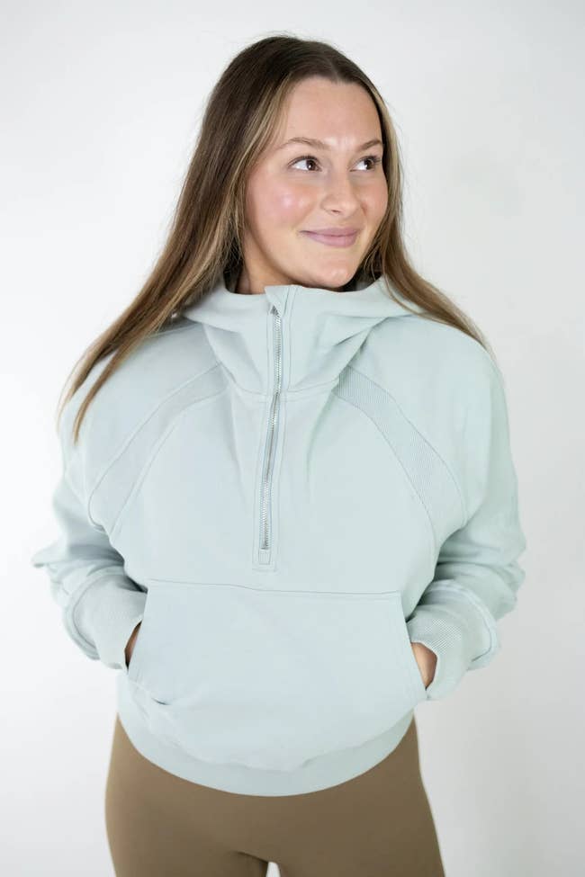 model wearing the hoodie in sage