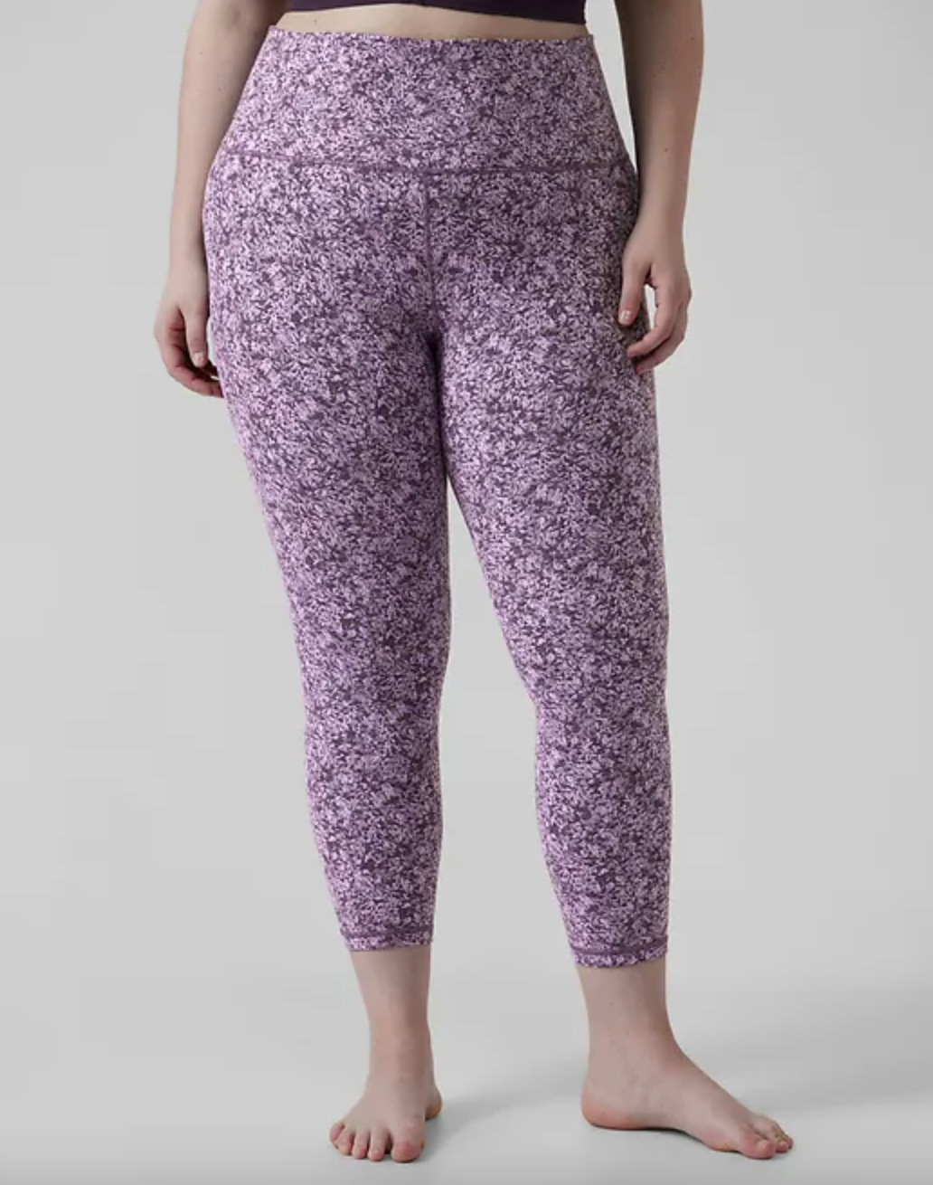 model wearing pink and purple printed leggings