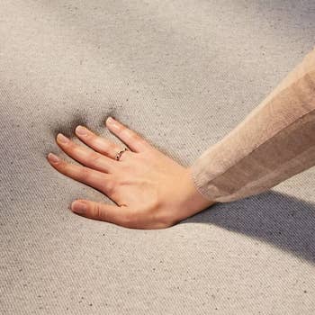 a hand showing how soft a casper mattress is