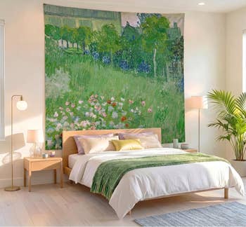 Bedroom with a wood   bed, greenish  throw, ample  floral tapestry connected  wall, nightstand, and potted plant, creating a serene, nature-inspired decor