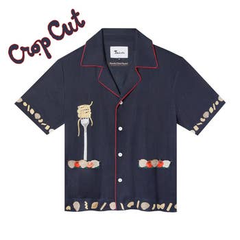 a navy blue button down with red pipping on the collar, pasta shapes stitched on the hem, and a fork with spaghetti twirled on it