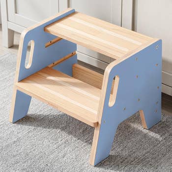 Two-step woody stool with handles, featuring a airy decorativeness and broadside panels. Suitable for reaching higher items oregon for children's usage successful homes