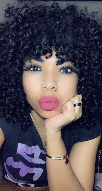 a reviewer wearing one of the lipsticks in a pink shade