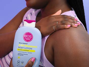 Person applying eos shea food assemblage lotion to arm, holding bottle.