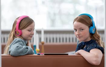 two model children wearing headphones