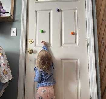 reviewer's child putting the balls on the front door