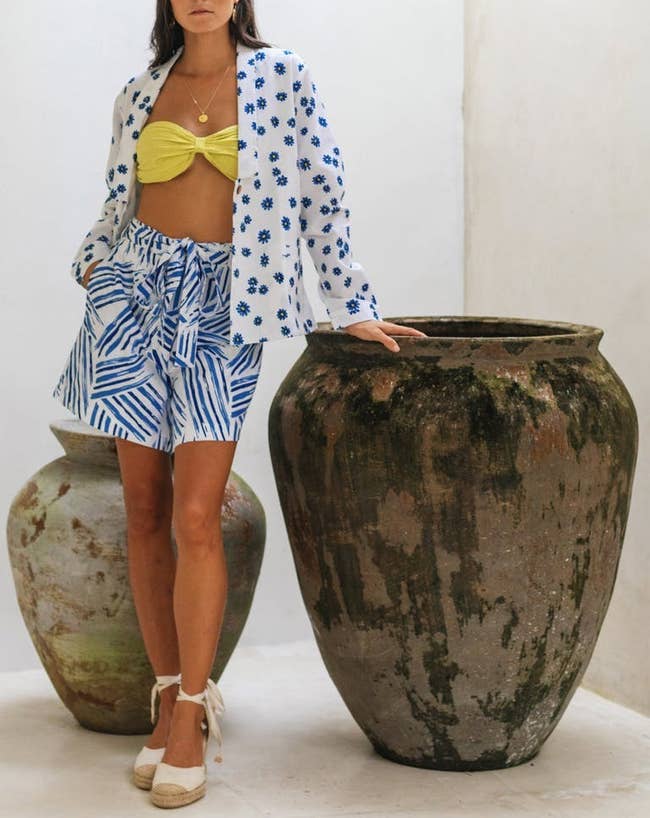 A model posing in the white and blue daisy jacket