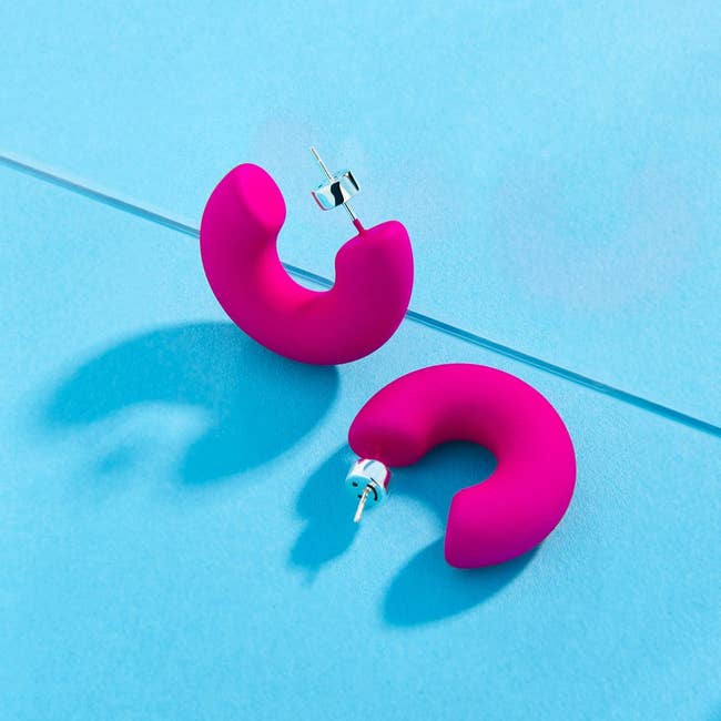 the hot pink earrings with the smiley face back