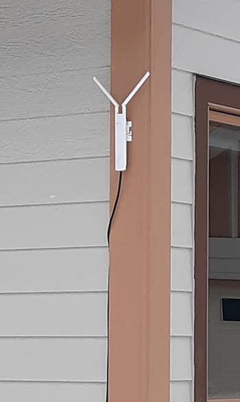 a reviewer photo of the extender mounted on a pole outside 