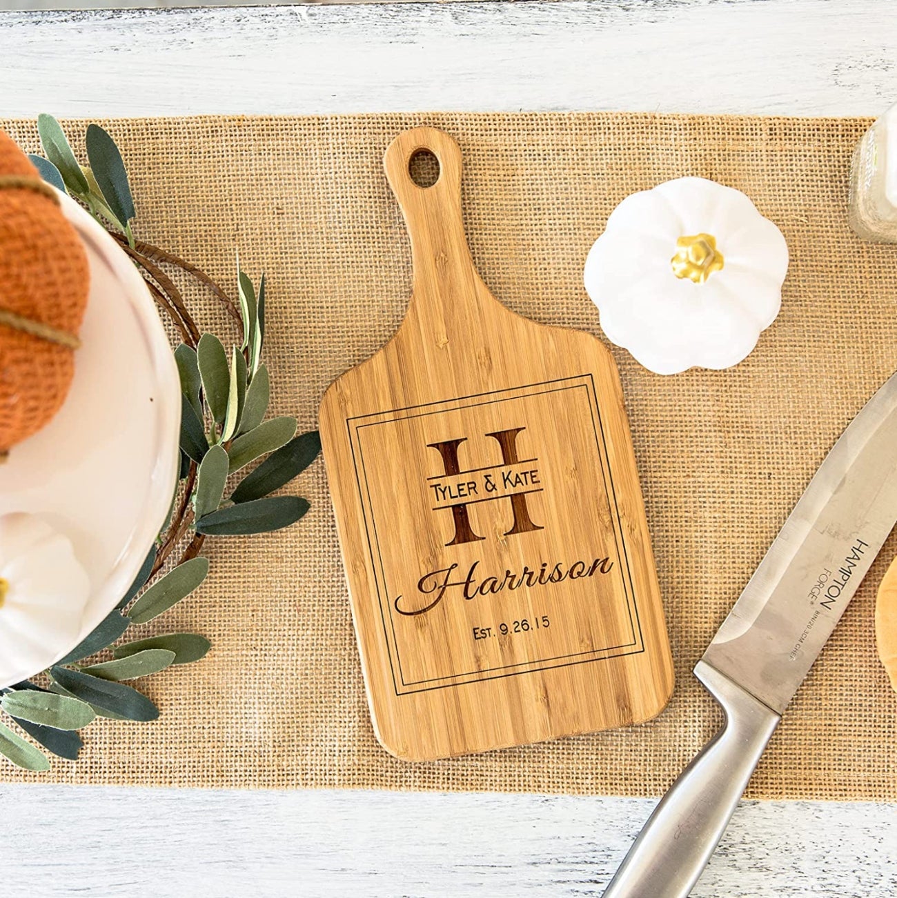 the cutting board displayed on a table with seasonal decor