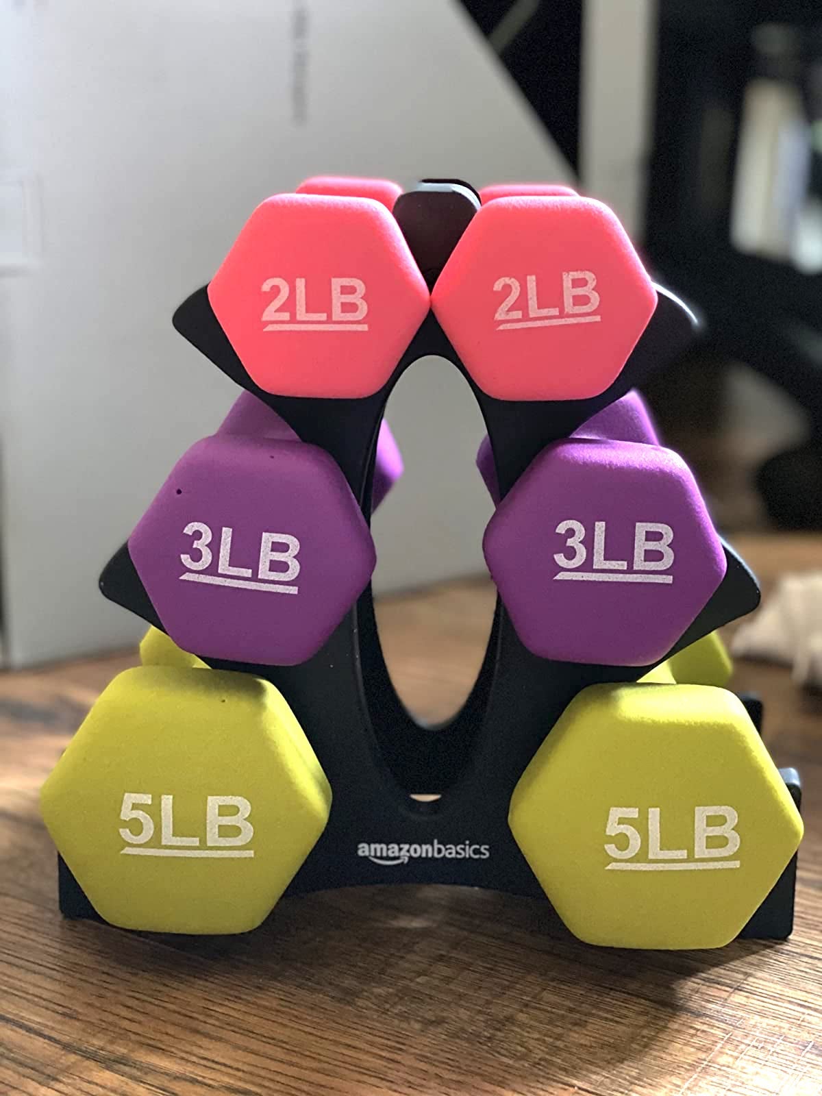 a reviewer photo of the dumbbells in two three and five pounds