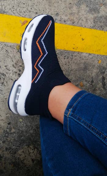 reviewer wearing the navy blue sneakers