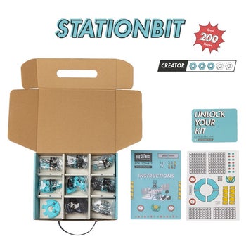 Opened StationBit box with all of the parts, instructions, and stickers 