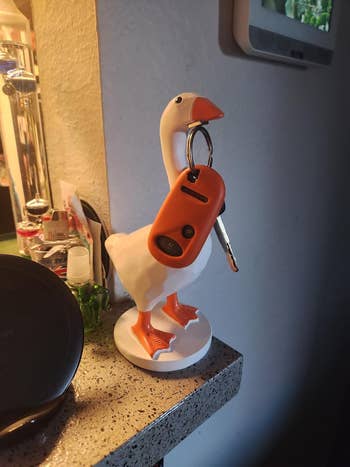  goose cardinal  holder connected  a countertop