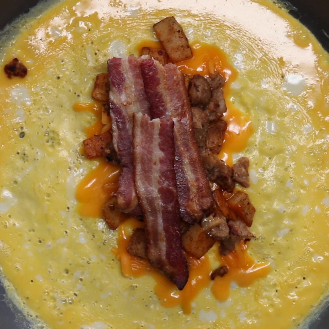 Bacon & Sausage Egg Wrapped Breakfast Burrito Recipe by Tasty image